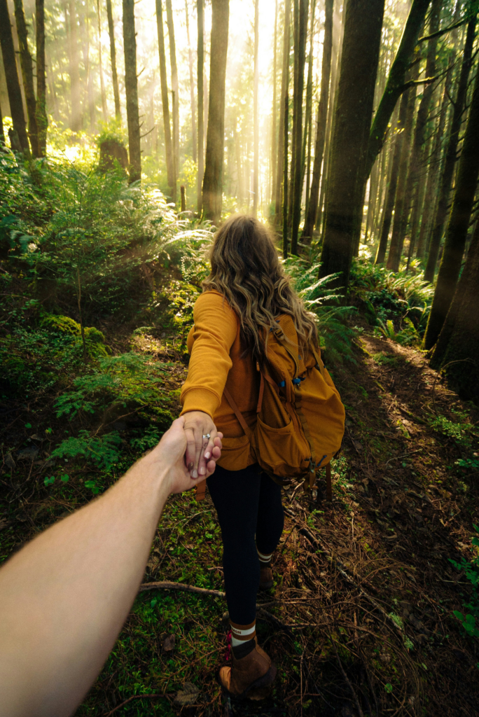 Couple holding hands in forest